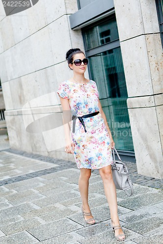 Image of attractive woman with sunglasses in the city summertime