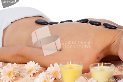 Image of attractive healthy caucasian woman hot stone massage wellness 
