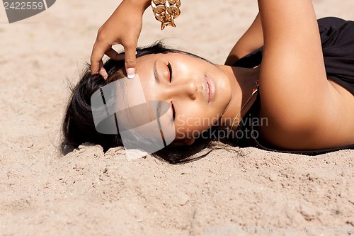 Image of beautiful asian woman with colorful makeup on the beach 