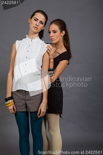 Image of two beutiful brunette girls in casual fashion and accessory 