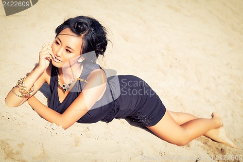 Image of beautiful asian woman with colorful makeup on the beach 