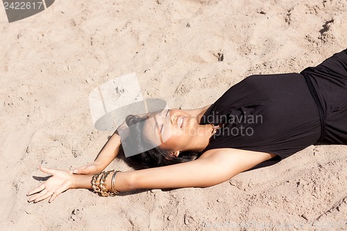 Image of beautiful asian woman with colorful makeup on the beach 
