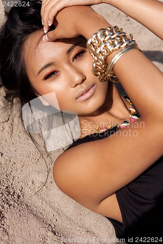 Image of beautiful asian woman with colorful makeup on the beach 