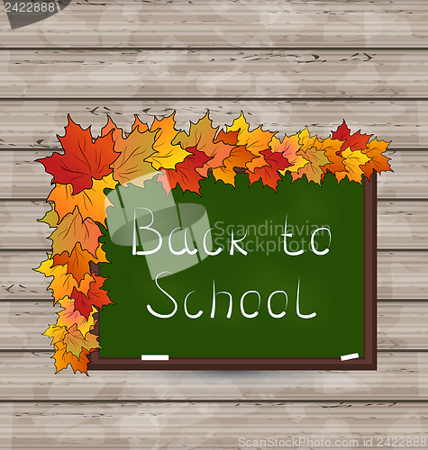Image of School green board with leaves on wooden texture