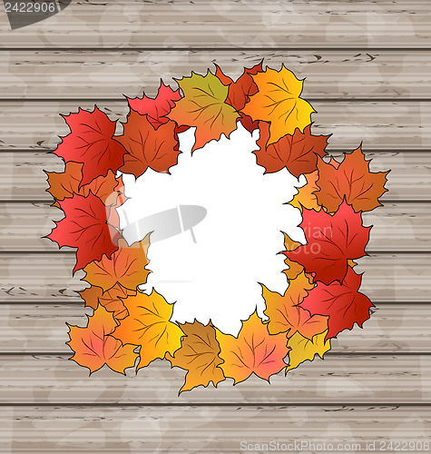 Image of Autumn leaves maple with copy space, wooden texture
