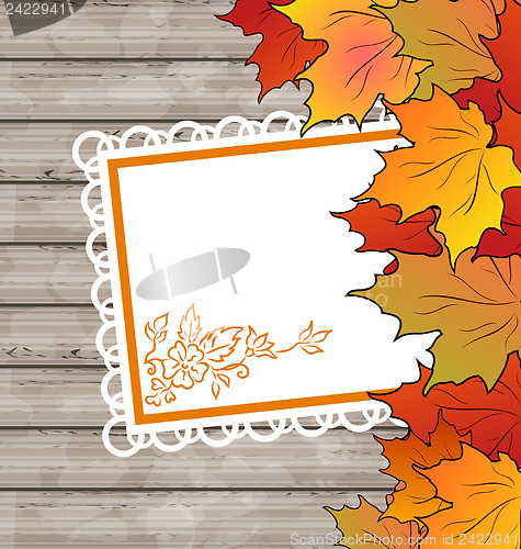 Image of Autumn card with leaves maple, wooden texture