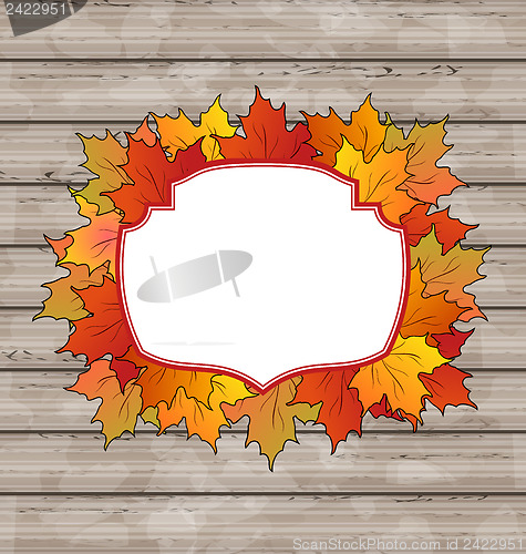 Image of Autumn label with leaves maple, wooden texture