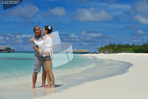 Image of happy young couple have fun on beach