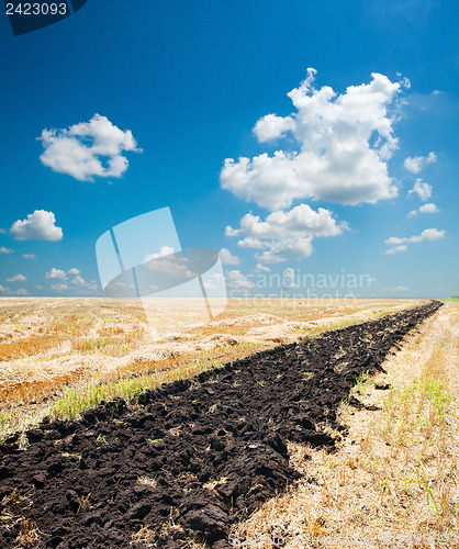 Image of ploughed field under blue sky