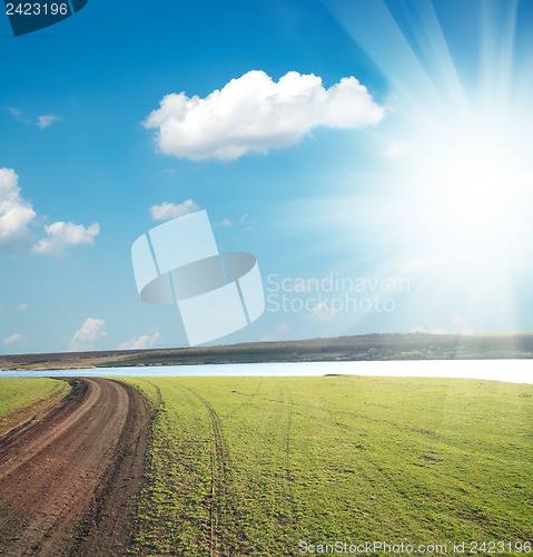 Image of dirty way to horizon under sun and clouds