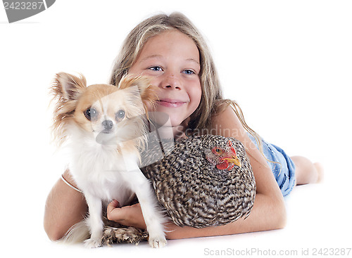 Image of child, dog and chicken