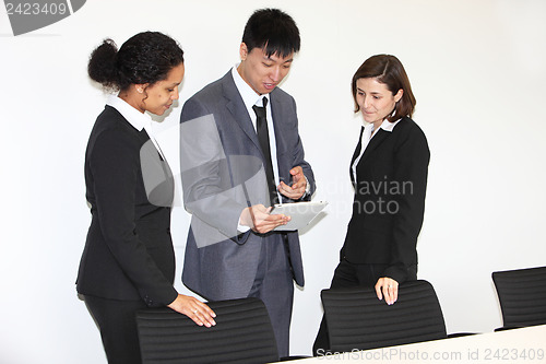 Image of Three businesspeople having a discussion
