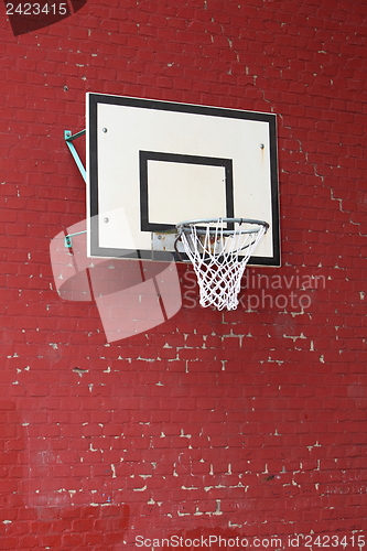 Image of Basket hoop fixed on a red brick wall