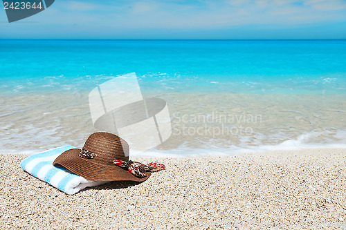 Image of Hat and towel on a beach