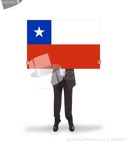 Image of Businessman holding a big card, flag of Chile
