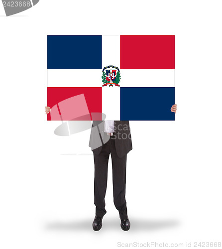 Image of Businessman holding a big card, flag of the dominican republic