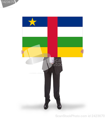 Image of Businessman holding a big card, flag of CAR