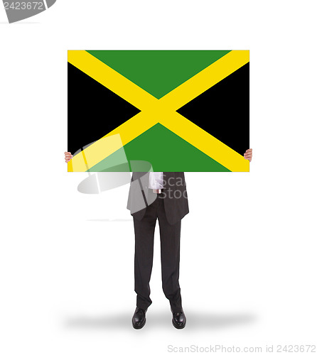 Image of Businessman holding a big card, flag of Jamaica