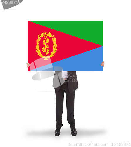 Image of Businessman holding a big card, flag of Eritrea
