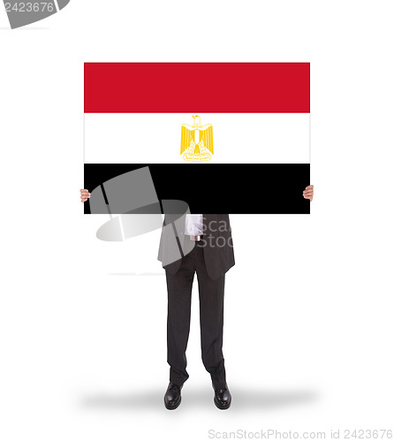 Image of Businessman holding a big card, flag of Egypt