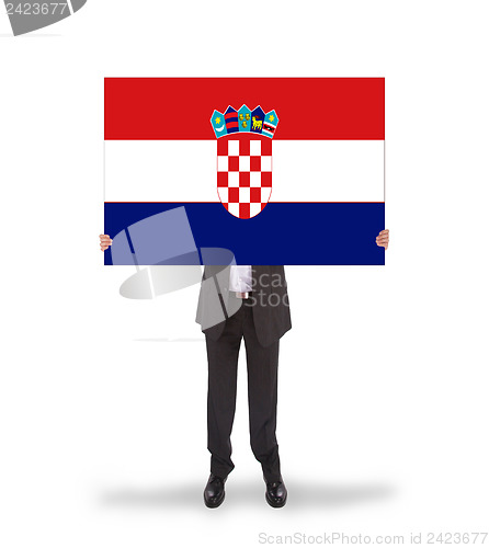 Image of Businessman holding a big card, flag of Croatia