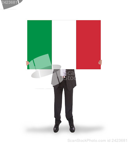 Image of Businessman holding a big card, flag of Italy