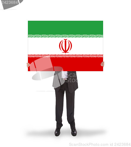 Image of Businessman holding a big card, flag of Iran