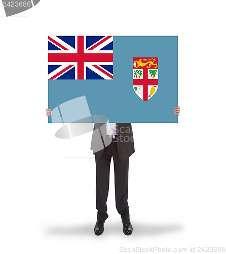 Image of Businessman holding a big card, flag of Fiji