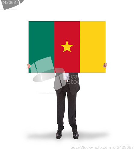 Image of Businessman holding a big card, flag of Cameroon