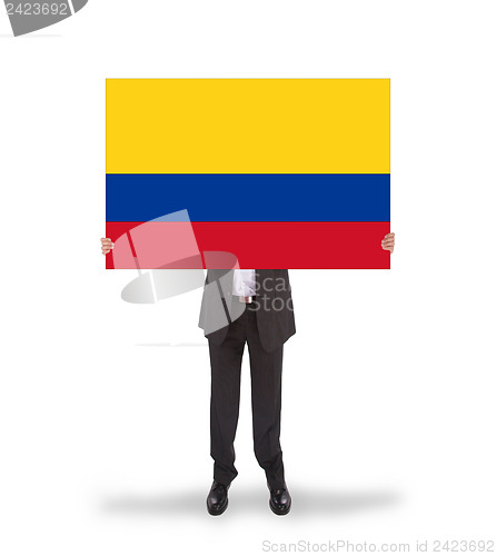 Image of Businessman holding a big card, flag of Colombia