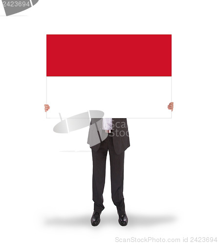 Image of Businessman holding a big card, flag of Indonesia