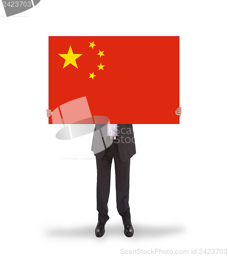 Image of Businessman holding a big card, flag of China