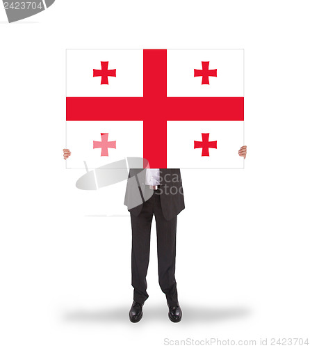 Image of Businessman holding a big card, flag of Georgia