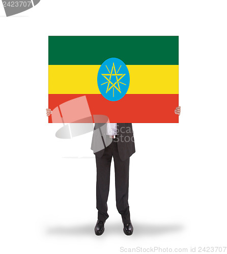 Image of Businessman holding a big card, flag of Ethiopia