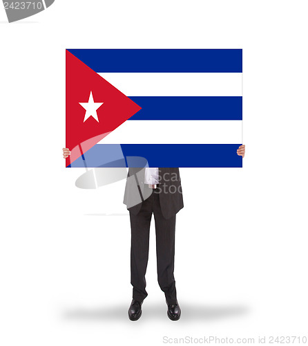 Image of Businessman holding a big card, flag of Cuba