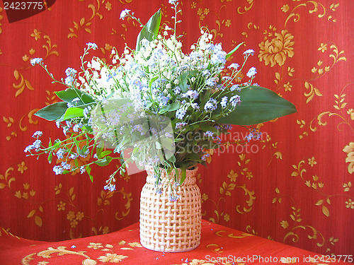 Image of bouquet of lilies of the valley and blue flowers