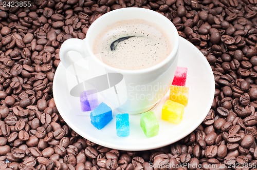 Image of Multicolored slabs of shugar and cup of coffee