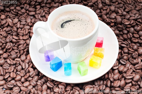 Image of Multicolored slabs of shugar and cup of coffee