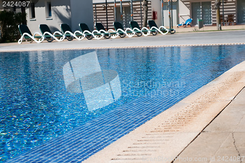Image of Pool and  chaise longues