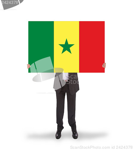 Image of Businessman holding a big card, flag of Senegal