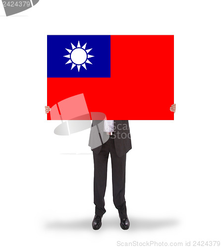 Image of Businessman holding a big card, flag of Taiwan