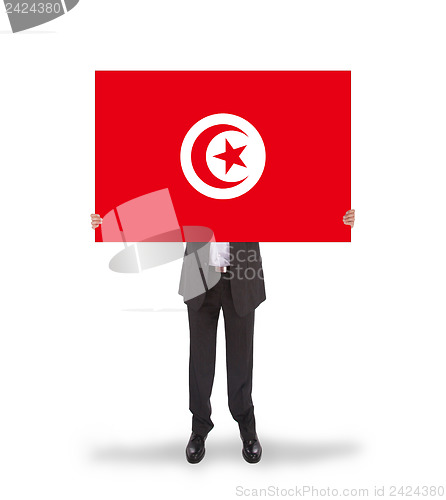 Image of Businessman holding a big card, flag of Tunisia