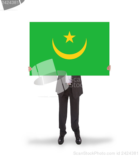 Image of Businessman holding a big card, flag of Mauritania