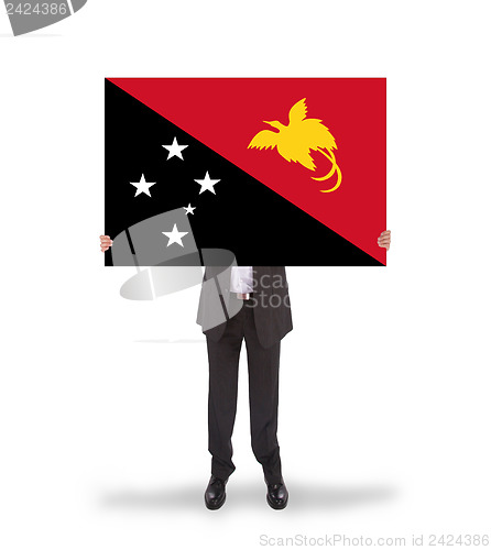 Image of Businessman holding a big card, flag of Papua New Guinea