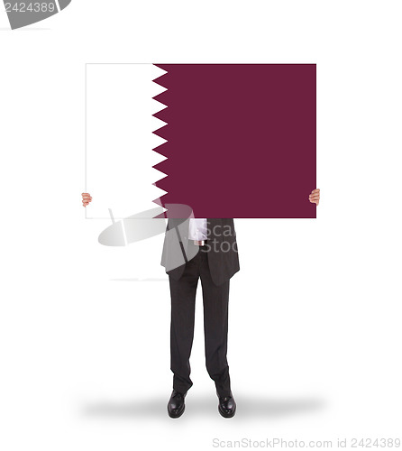 Image of Businessman holding a big card, flag of Qatar