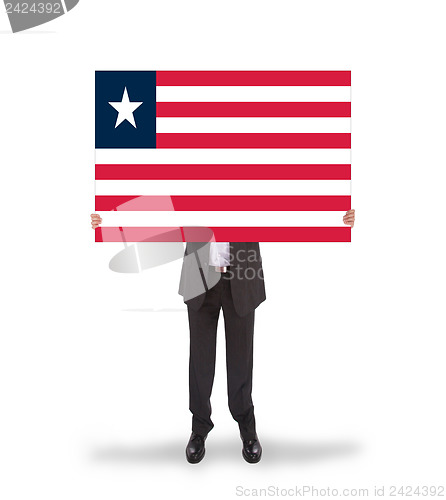 Image of Businessman holding a big card, flag of Liberia