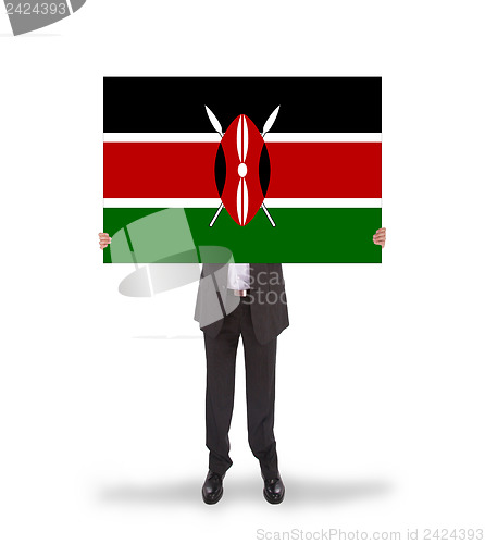 Image of Businessman holding a big card, flag of Kenya