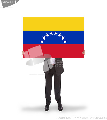 Image of Businessman holding a big card, flag of Venezuela