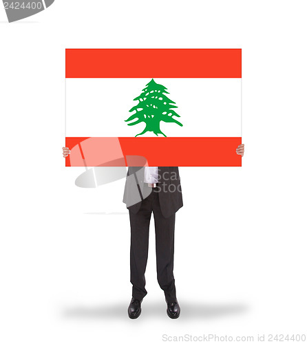 Image of Businessman holding a big card, flag of Lebanon