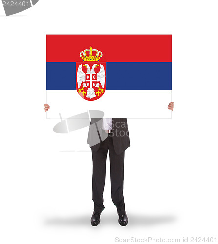 Image of Businessman holding a big card, flag of Serbia